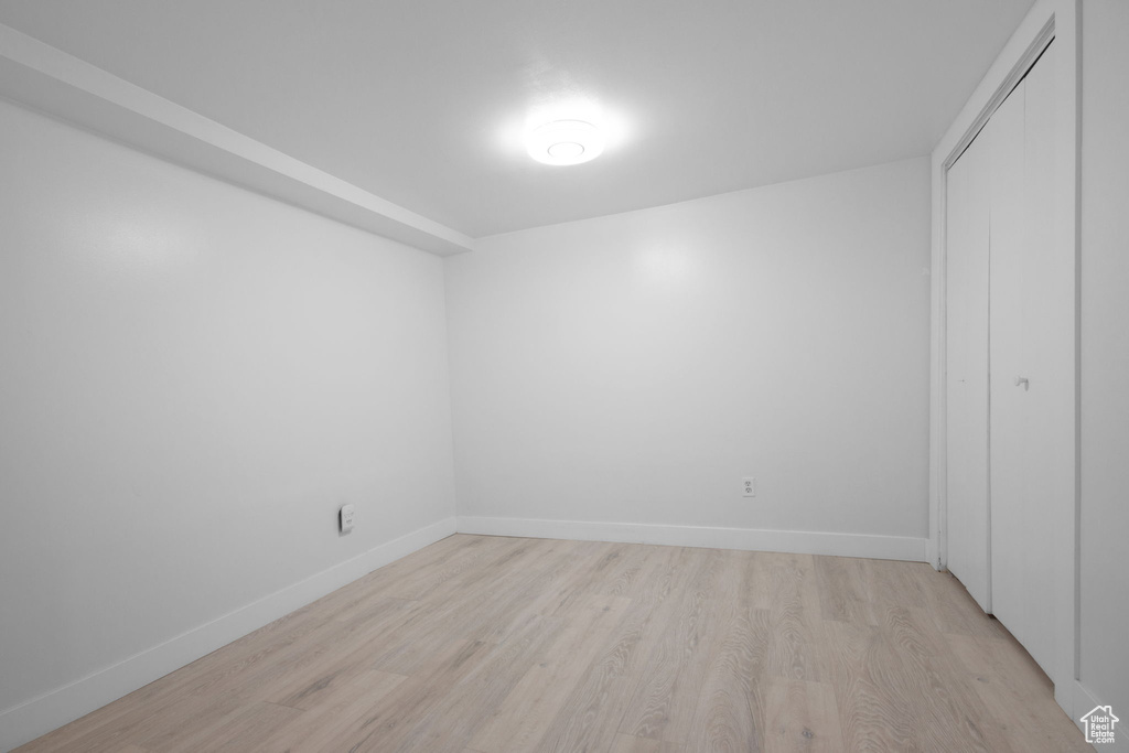 Unfurnished bedroom with a closet and light wood-type flooring