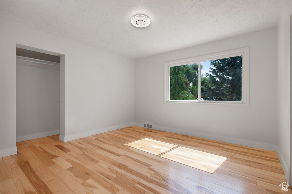 Unfurnished bedroom featuring a closet and light wood-type flooring