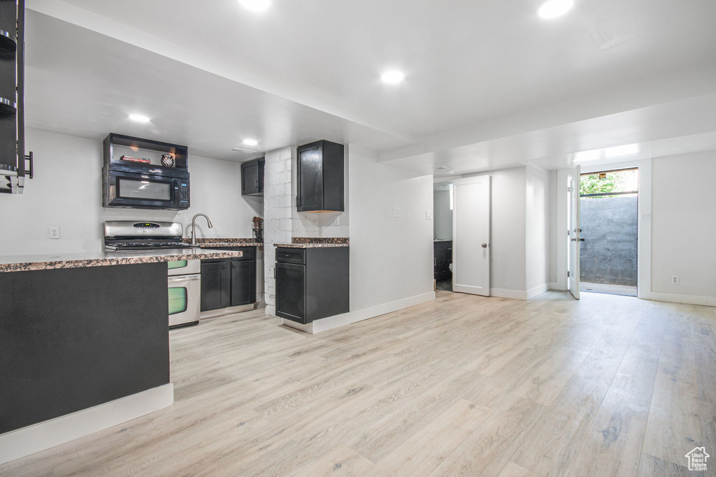 Kitchen featuring electric stove and light hardwood / wood-style flooring