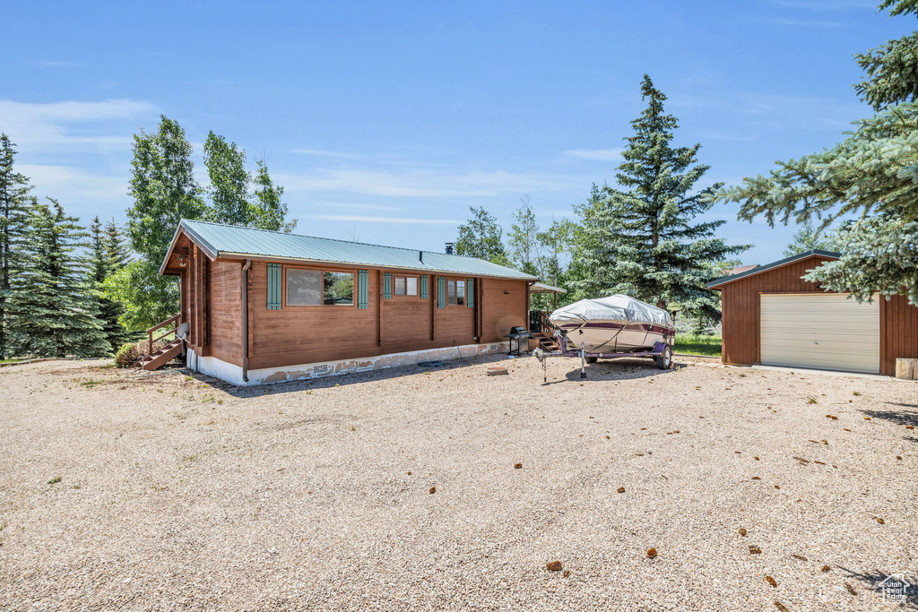 View of front of property with an outdoor structure and a garage