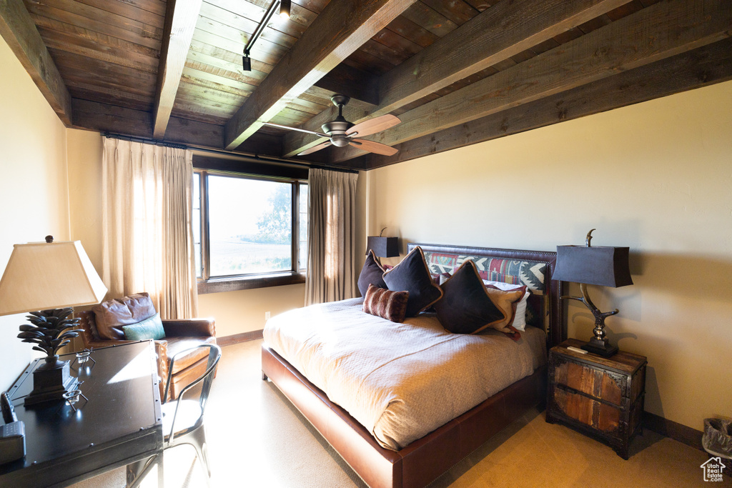 Bedroom with wooden ceiling, ceiling fan, and beam ceiling