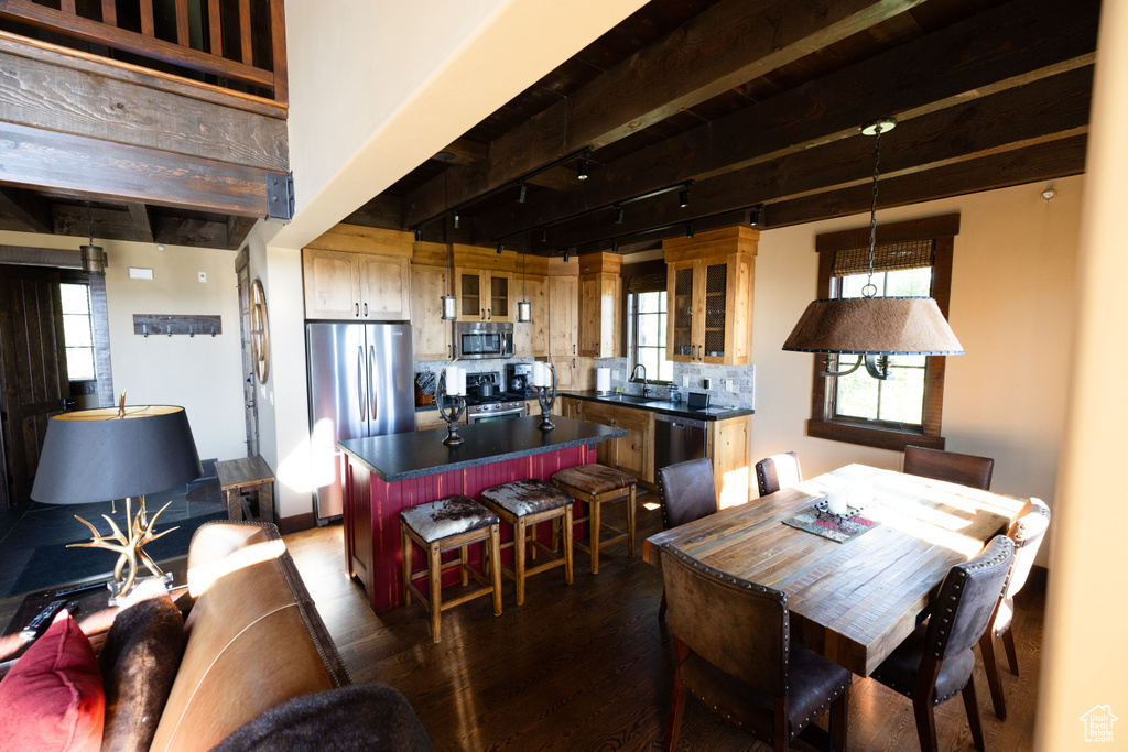 Dining space featuring sink and dark hardwood / wood-style floors