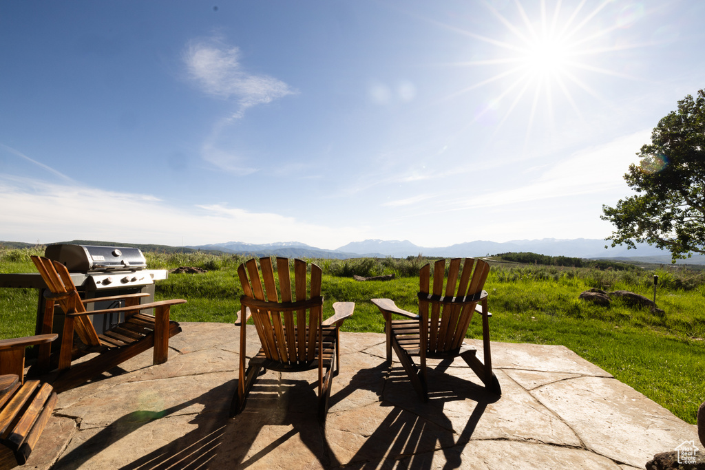 View of terrace featuring area for grilling and a mountain view