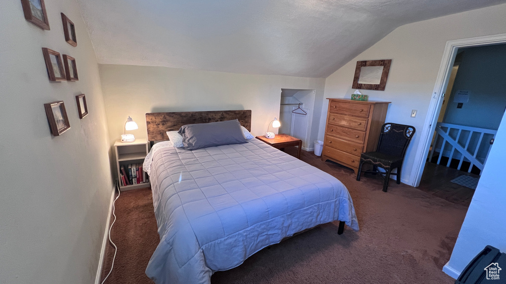 Carpeted bedroom with vaulted ceiling