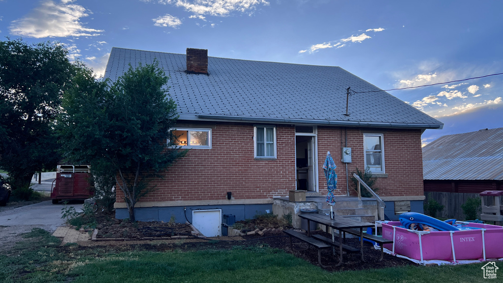 Rear view of house with a lawn