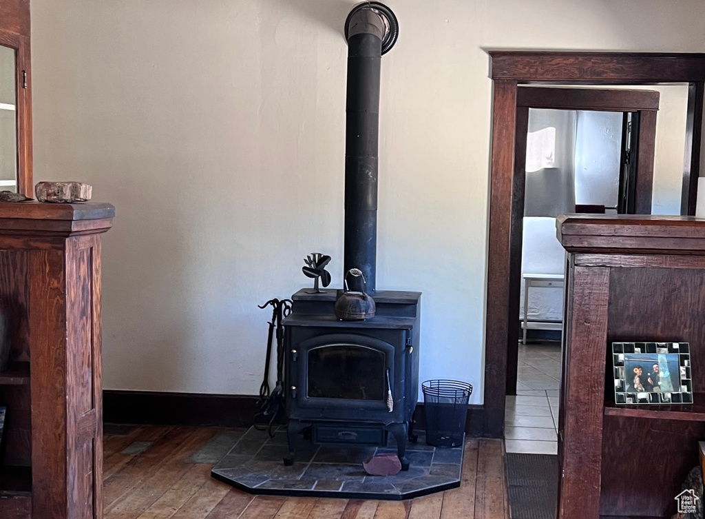 Details featuring hardwood / wood-style flooring and a wood stove