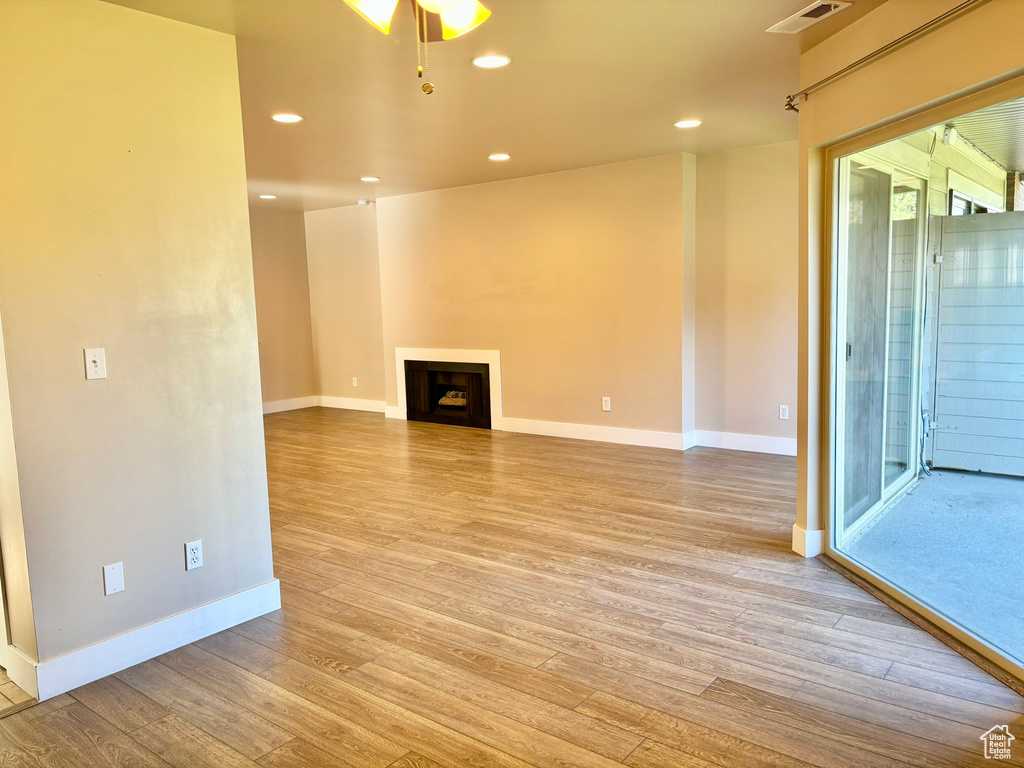 Unfurnished living room with light hardwood / wood-style floors