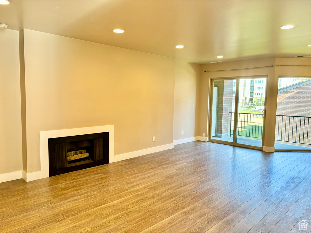 Unfurnished living room with light hardwood / wood-style floors