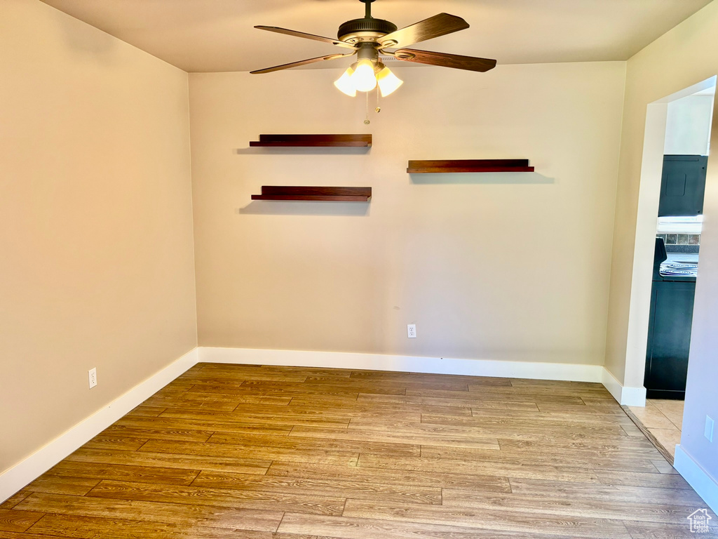 Spare room with hardwood / wood-style flooring and ceiling fan