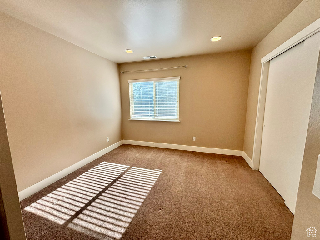 Unfurnished bedroom with a closet and carpet floors