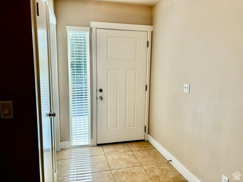 Tiled entryway with a wealth of natural light