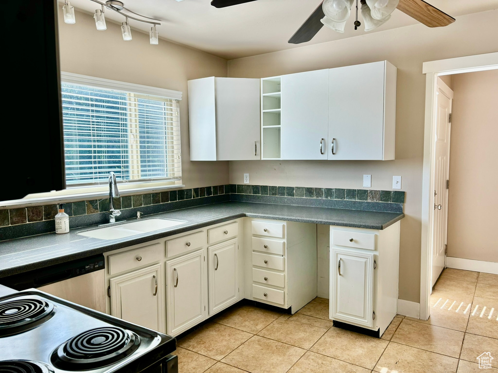 Kitchen featuring white cabinetry, sink, track lighting, ceiling fan, and light tile floors