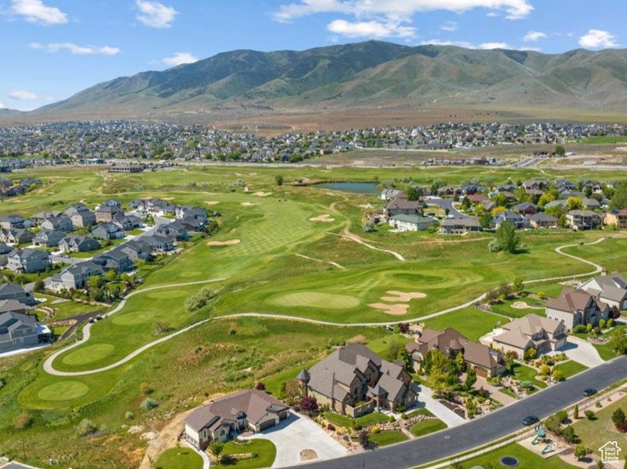 Aerial view of residential area featuring a local golf course and a water and mountain view