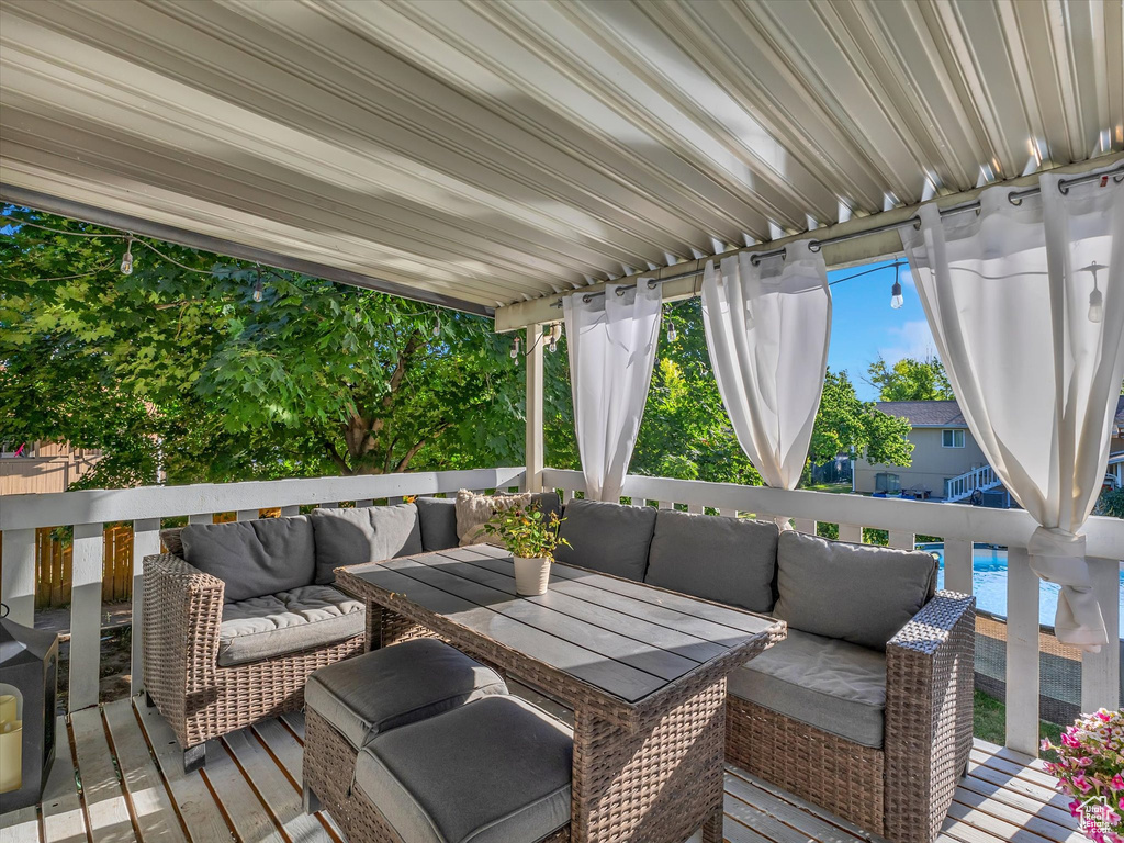 Wooden deck featuring outdoor lounge area