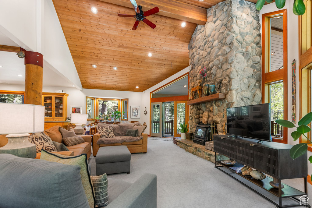 Living room featuring high vaulted ceiling, a wealth of natural light, carpet flooring, and ceiling fan
