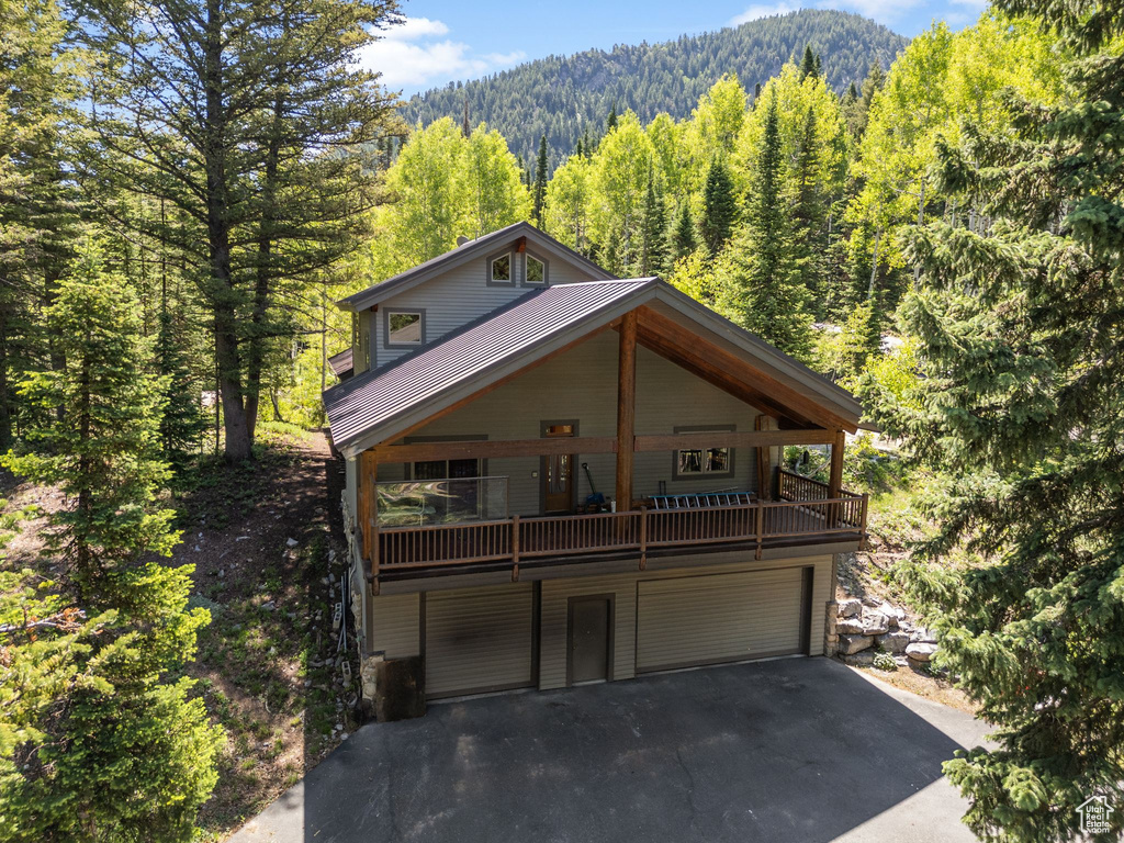 View of front of home with a garage and a mountain view