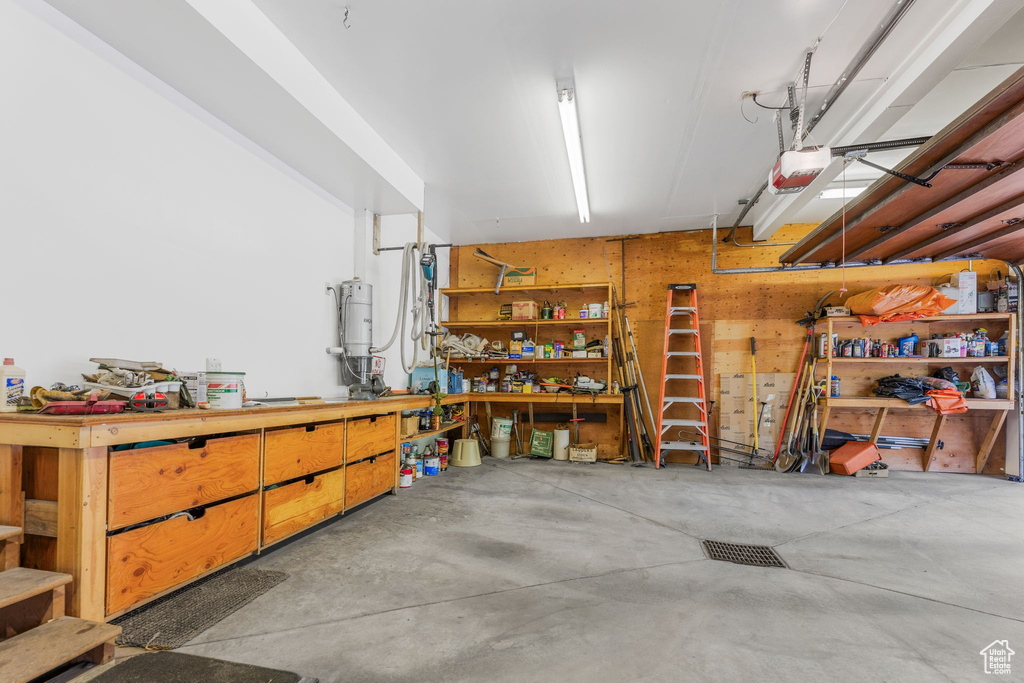 Garage featuring a workshop area and a garage door opener