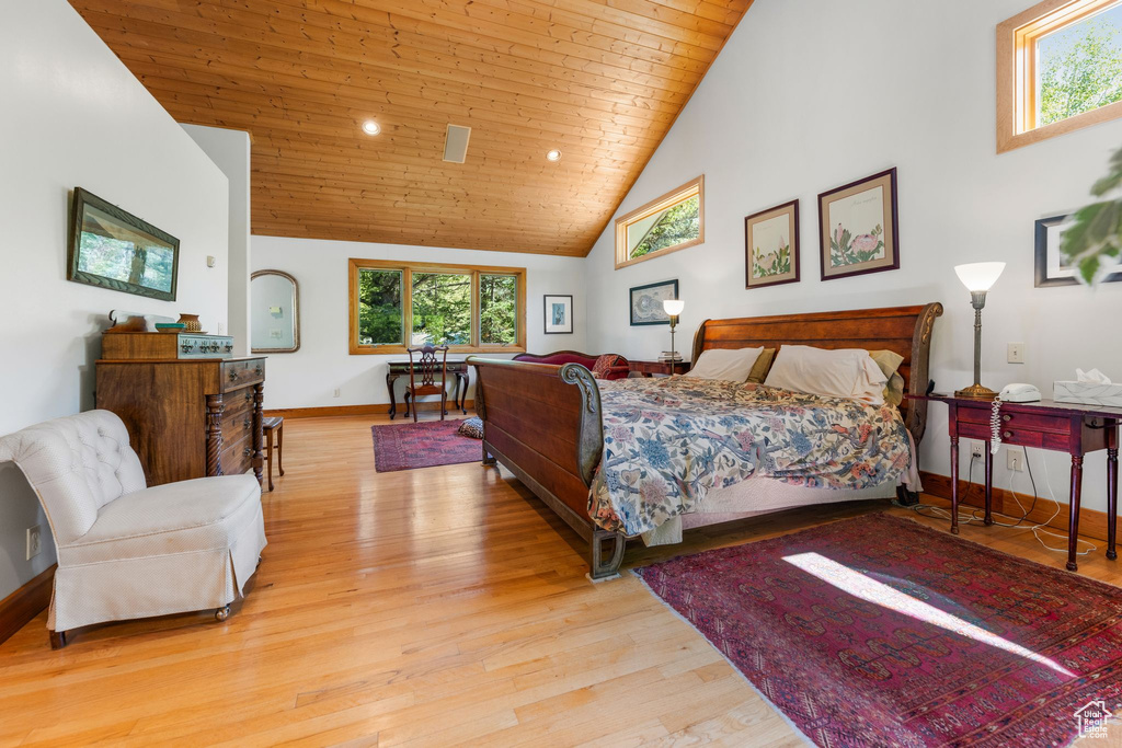 Bedroom with high vaulted ceiling, wood ceiling, and hardwood / wood-style floors