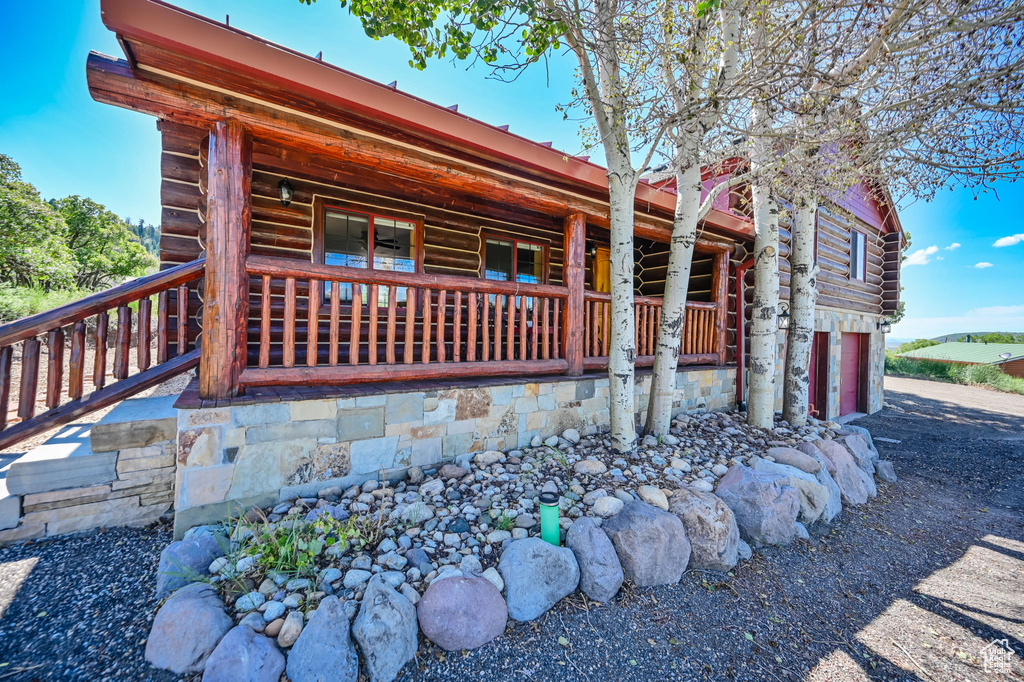 View of front of property featuring a porch and a garage