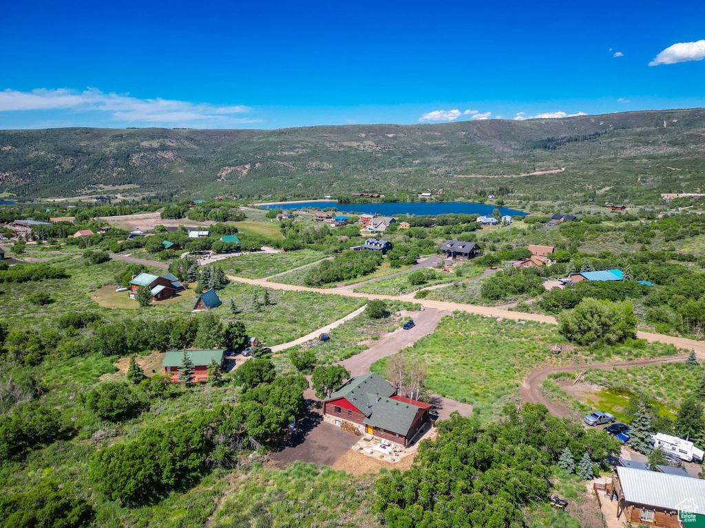 Drone / aerial view featuring a water and mountain view