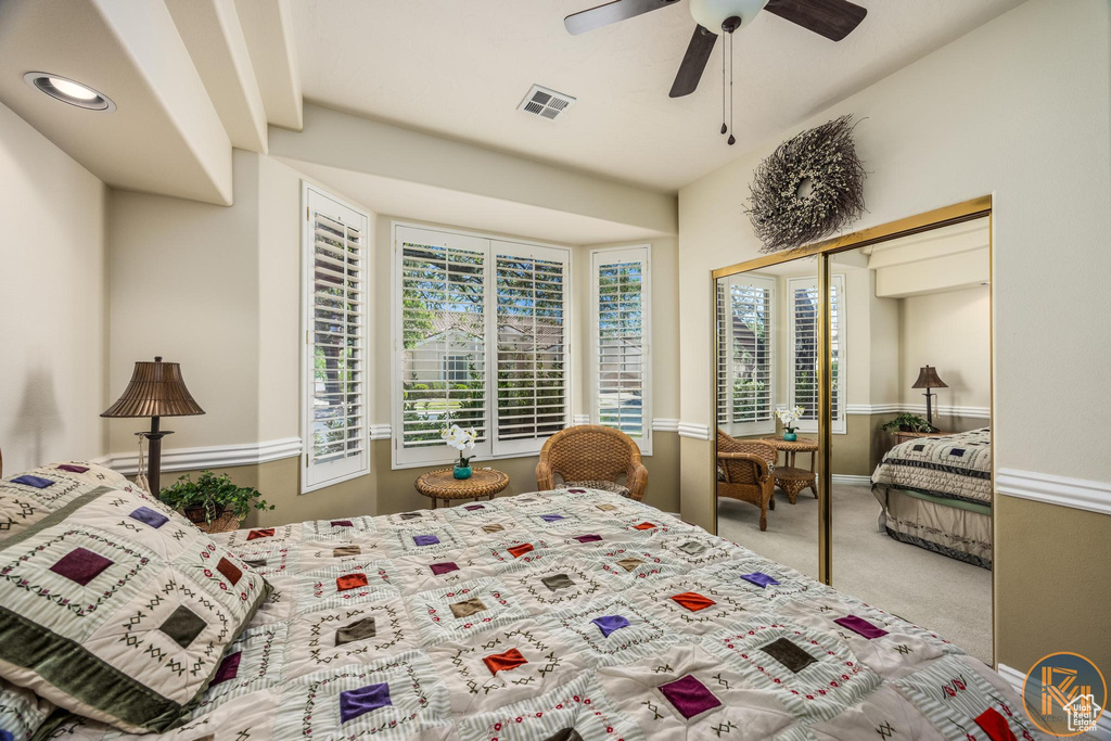 Carpeted bedroom featuring a closet and ceiling fan