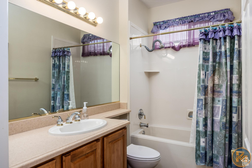 Full bathroom with vanity, toilet, and shower / tub combo with curtain