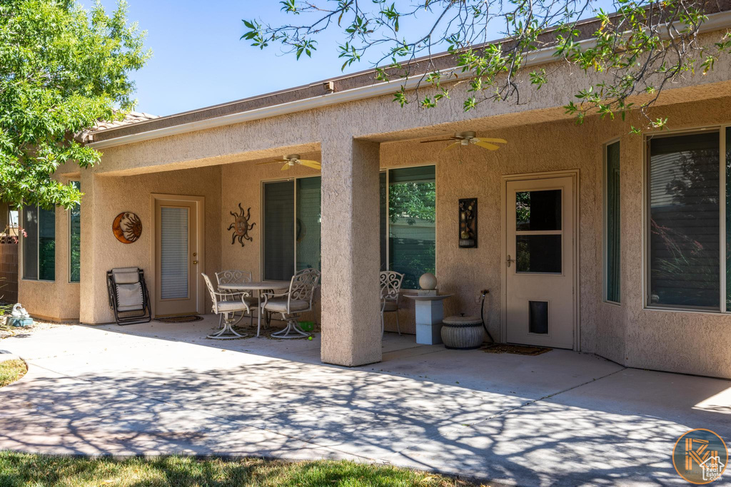 View of front facade with a patio area and ceiling fan