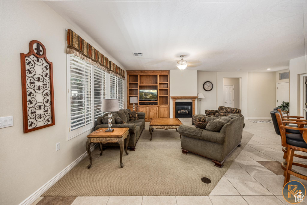 Living room featuring ceiling fan and light tile floors