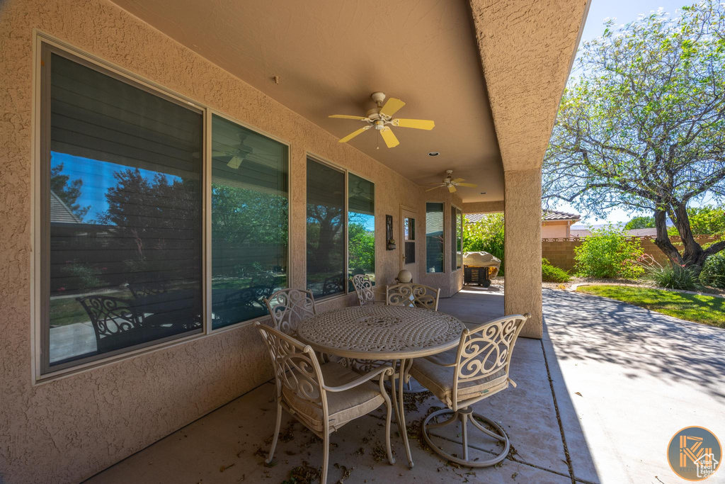 View of patio with ceiling fan and grilling area