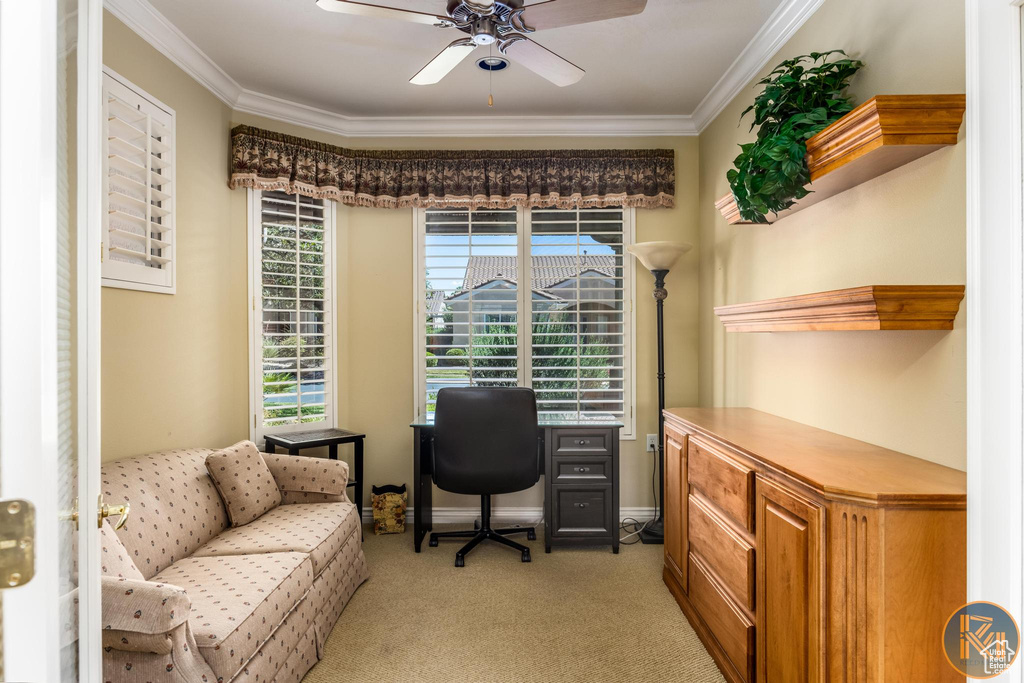 Carpeted home office featuring crown molding and ceiling fan