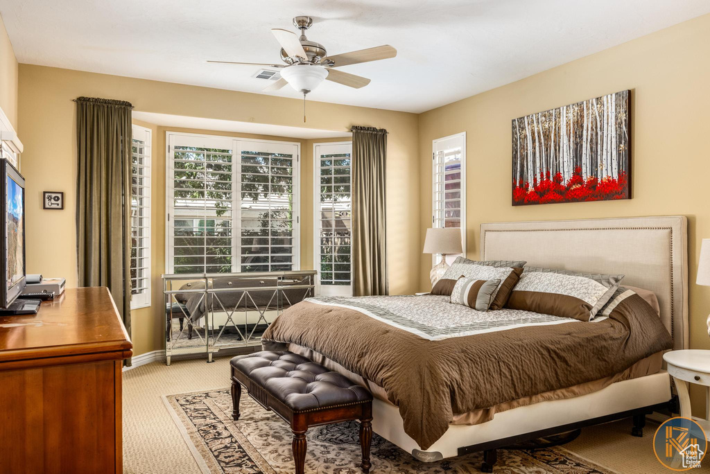 Carpeted bedroom with ceiling fan