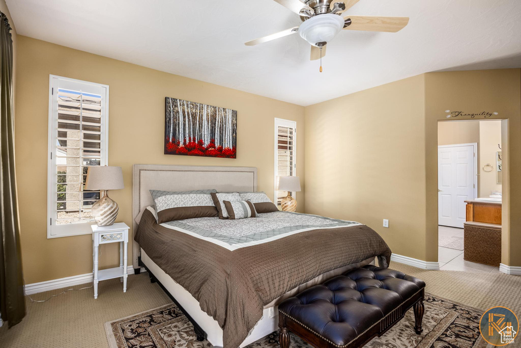 Carpeted bedroom featuring ceiling fan