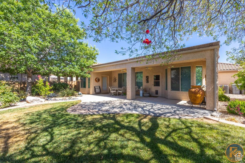 Back of property featuring a yard and a patio