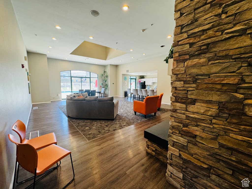 Living room featuring a raised ceiling and dark hardwood / wood-style flooring