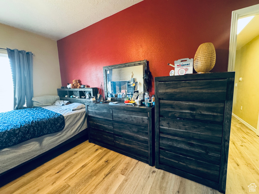 Bedroom with wood-type flooring