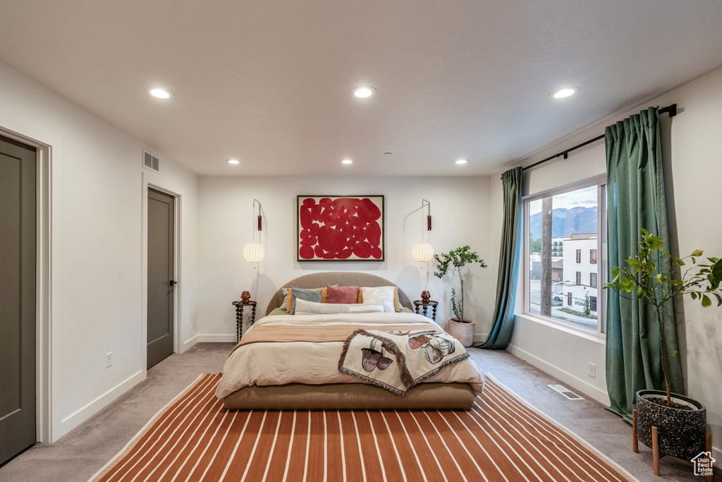 Bedroom featuring light carpet