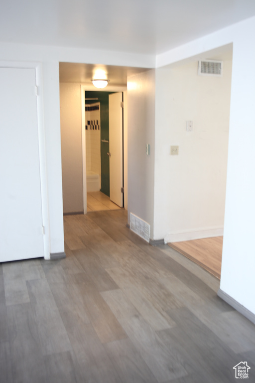 Empty room with hardwood / wood-style flooring