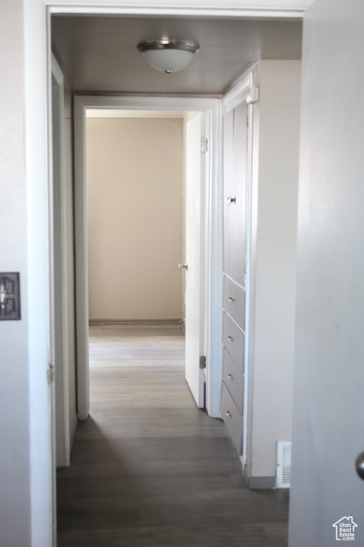 Hall with hardwood / wood-style floors