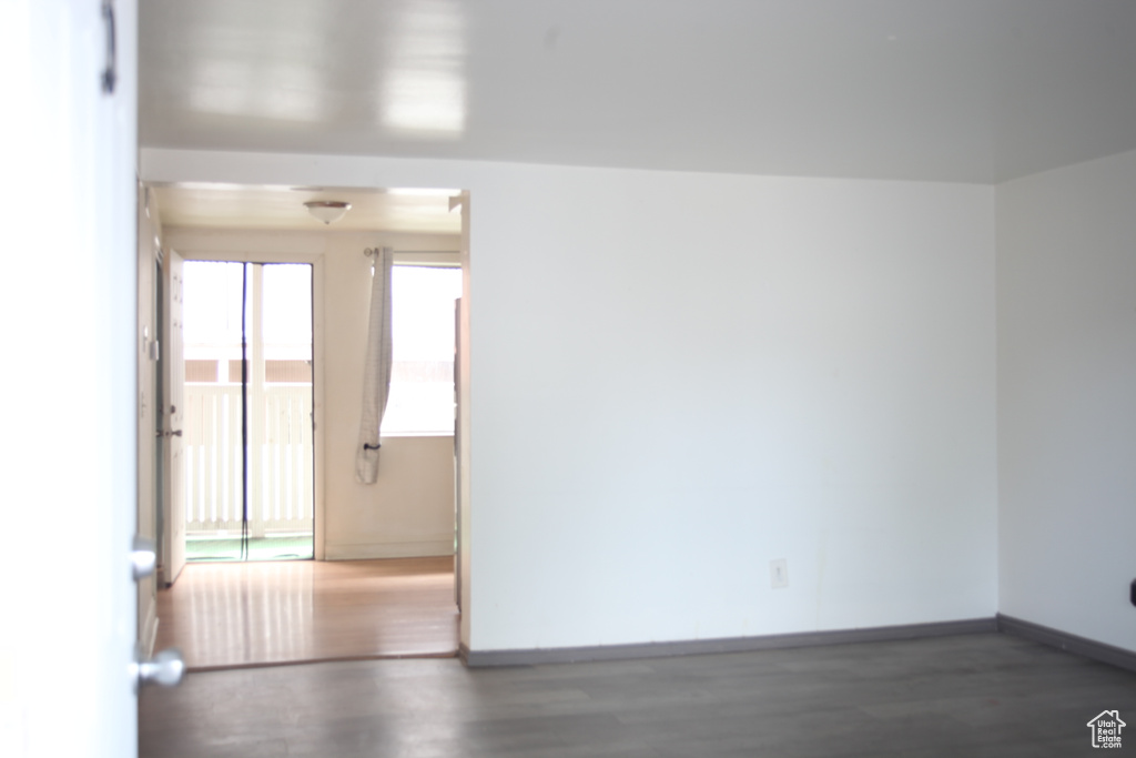 Unfurnished room featuring dark wood-type flooring