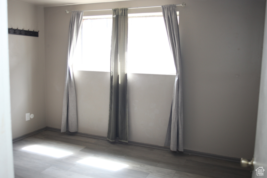 Empty room featuring dark wood-type flooring