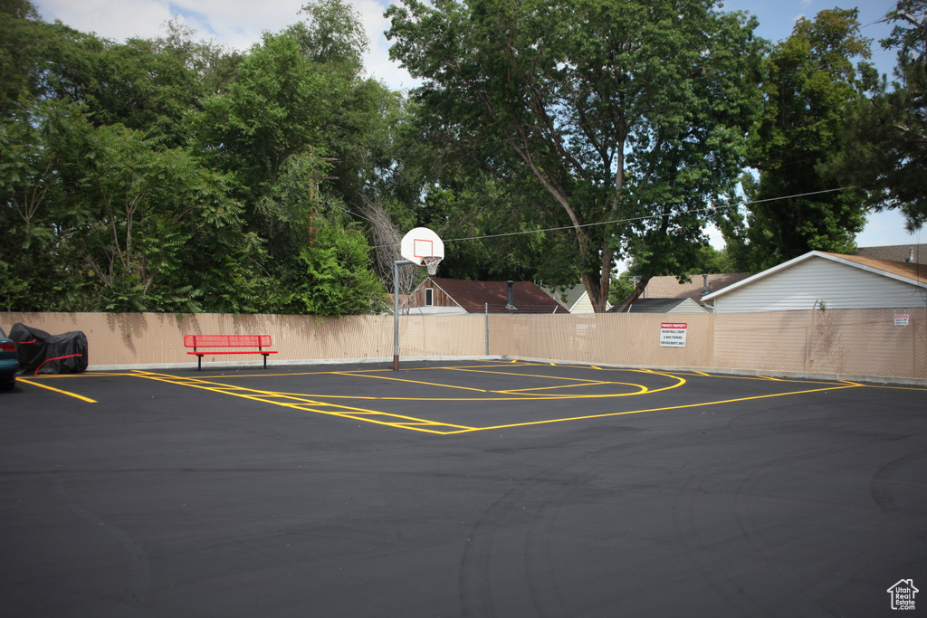 View of parking featuring basketball court