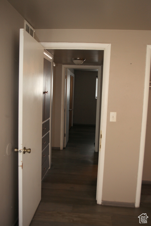 Corridor with dark hardwood / wood-style floors