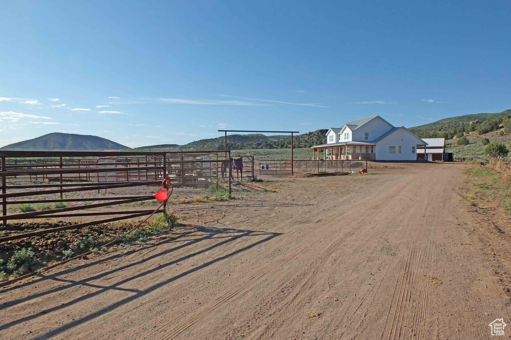 View of yard with a rural view and a mountain view