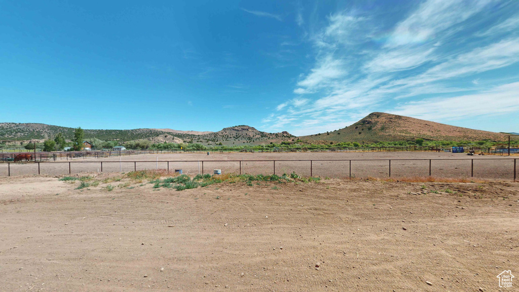 View of yard with a rural view and a mountain view