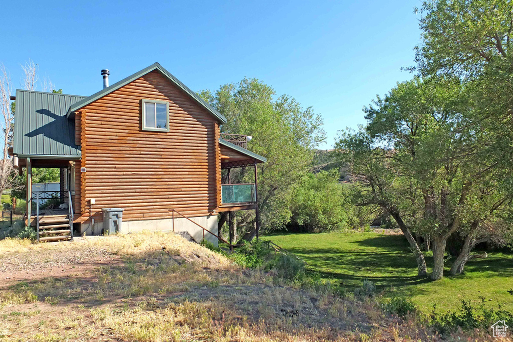 View of property exterior with a lawn