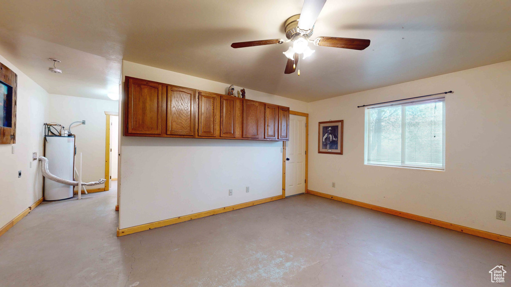 Interior space with ceiling fan and water heater