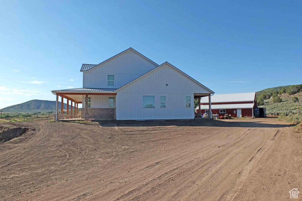 View of property exterior featuring a mountain view