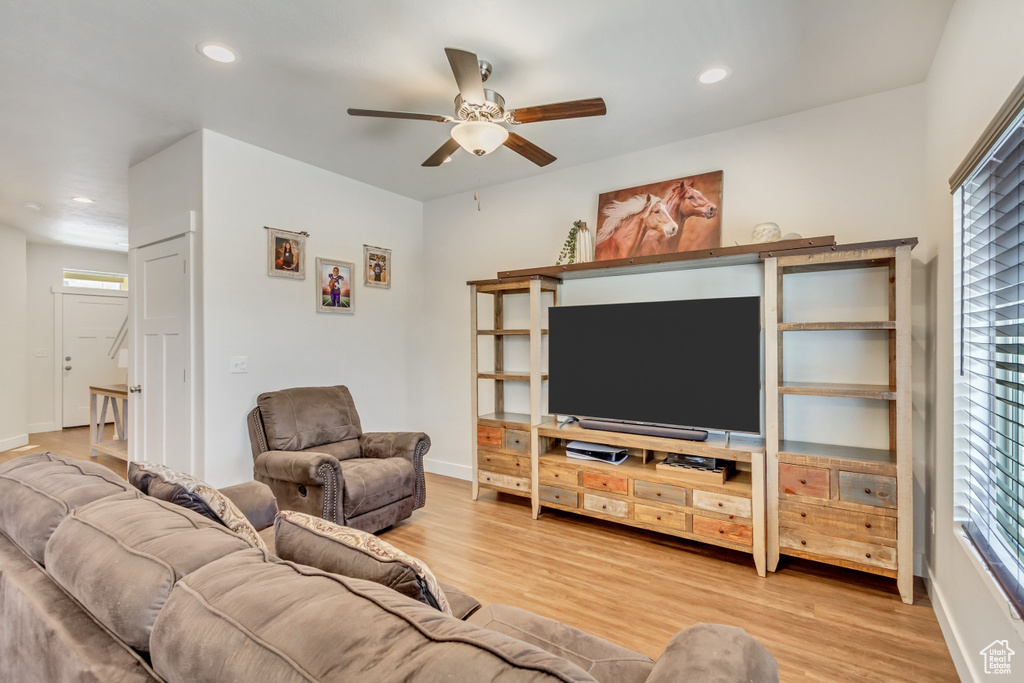 Living room featuring ceiling fan, light hardwood / wood-style flooring, and a wealth of natural light