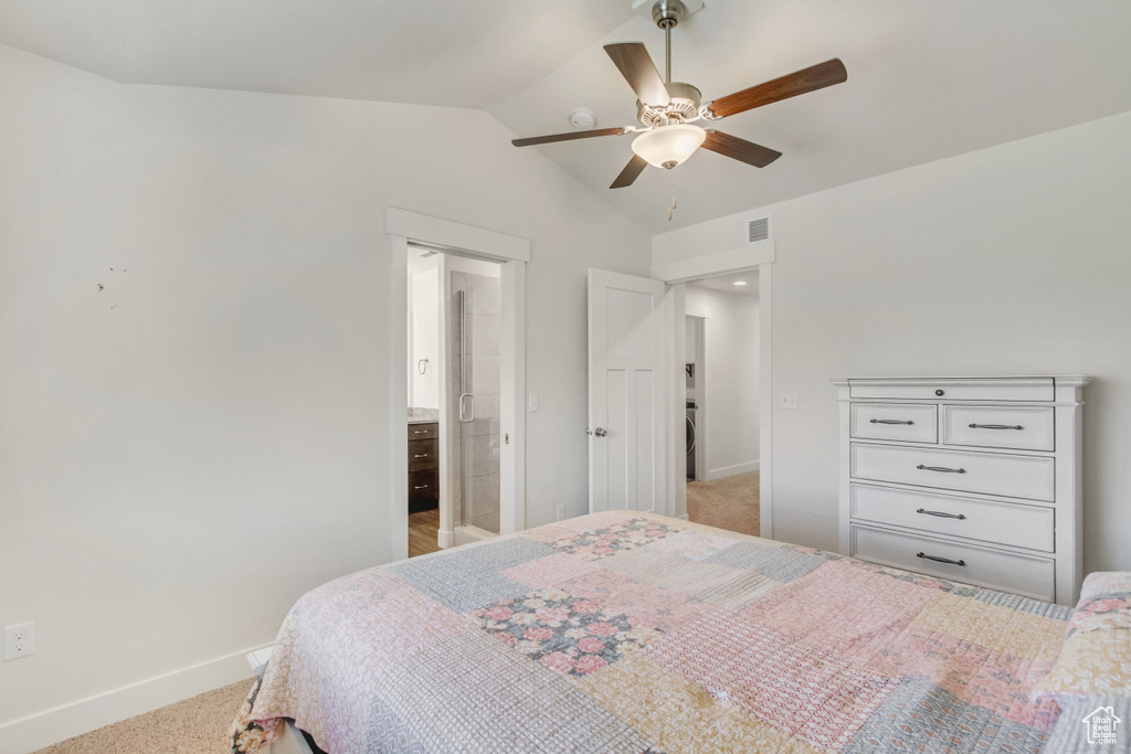 Carpeted bedroom with ceiling fan and vaulted ceiling