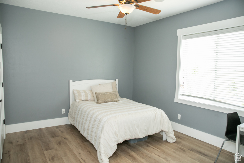 Bedroom with wood-type flooring and ceiling fan